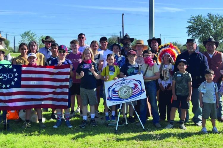 A group of volunteers who reenact scenes from the old west. One of their main roles in the community is honoring the protocol of retiring United States flags every Fourth of July. Photo by Ross Harper