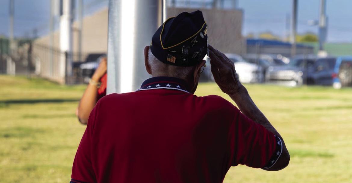Veteran, Alonso Martinez saluting the US flag. Courtesy Photo by Zachary Gray.