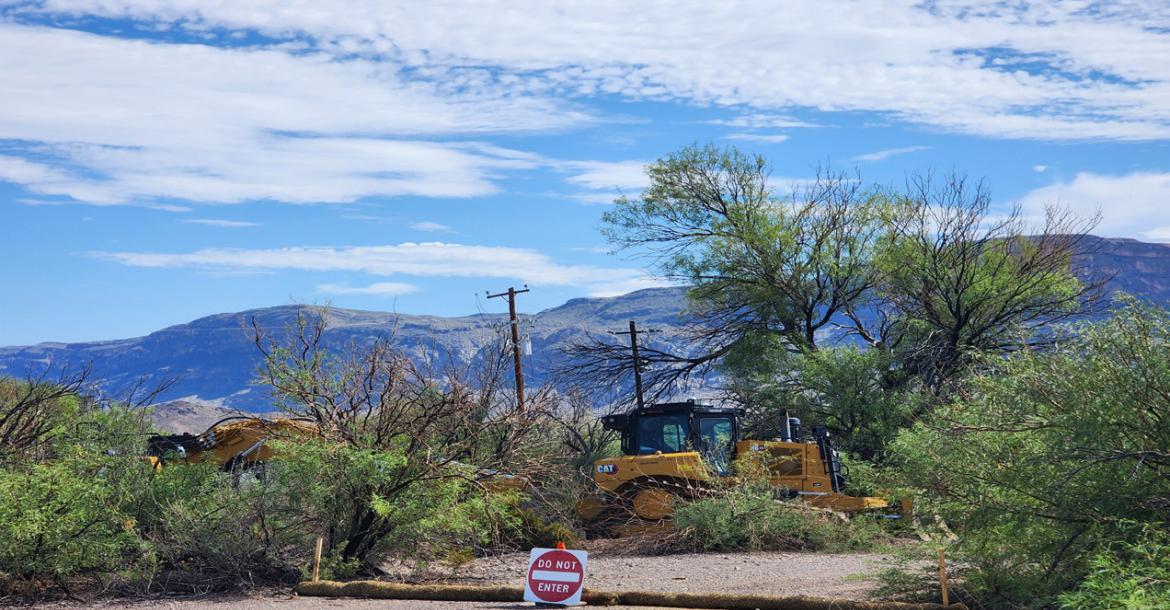 Heavy equipment rests silently on Sunday, August 16, after the border wall infrastructure began last week in Big Bend National Park. These machines were parked just past the turnoff to Cottonwood Campground, and the “new patrol road” essentially runs parallel to the already paved and maintained park road to Santa Elena Canyon. As of Sunday, the path runs from the parking lot at Santa Elena Canyon to this location. Photo by Kara Gerbert