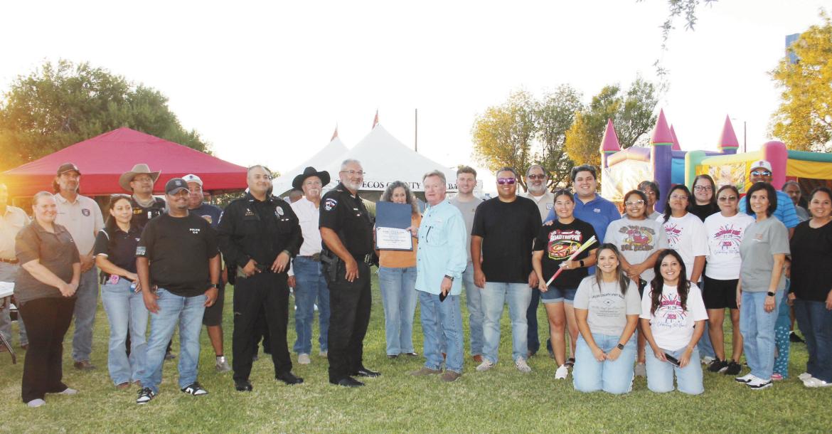 The Fort Stockton Police Department presents National Night Out recognitions to representatives of the First National Bank and Pecos County State Bank for hosting this year’s community event.