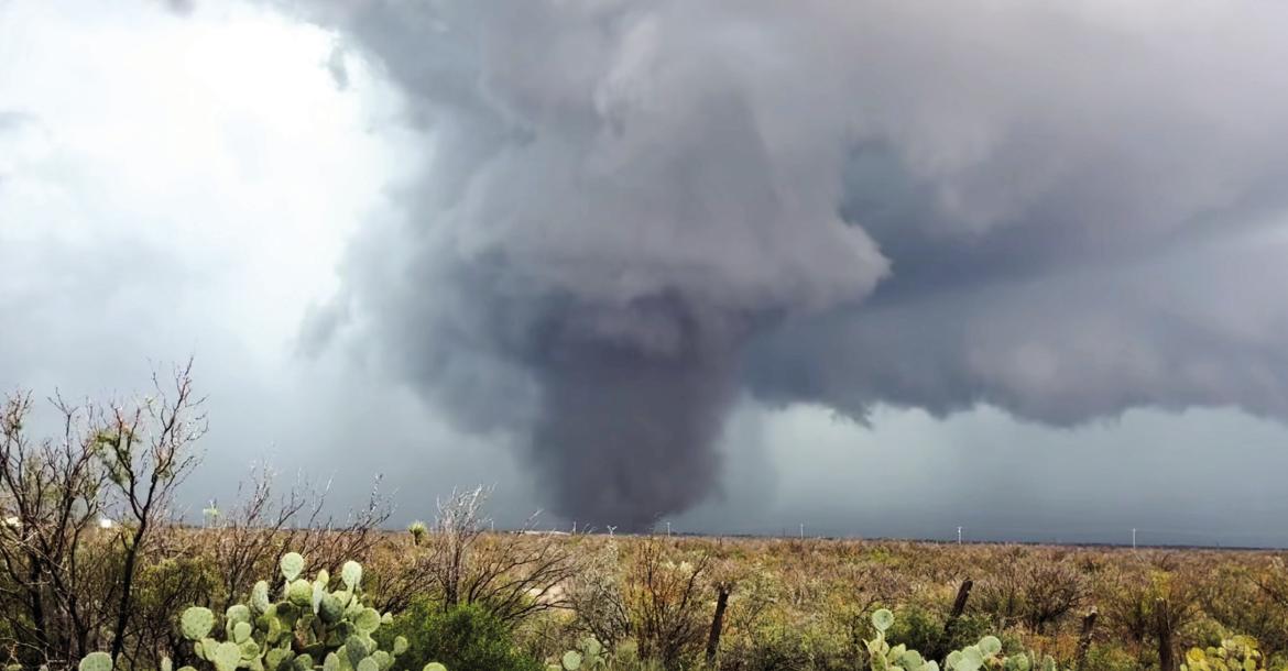 TWO TORNADOES CONFIRMED — A large tornado moves across a pasture near Fort Stockton on Oct. 14 as severe weather swept through Pecos County. The National Weather Service later confirmed two separate tornadoes: an EF0 that struck near downtown Fort Stockton and the Pecos County Courthouse, followed minutes later by an EF1 northeast of the city. Despite damage to trees, buildings, and property, no injuries or deaths were reported. Courtesy Photo by Kirby Warnock